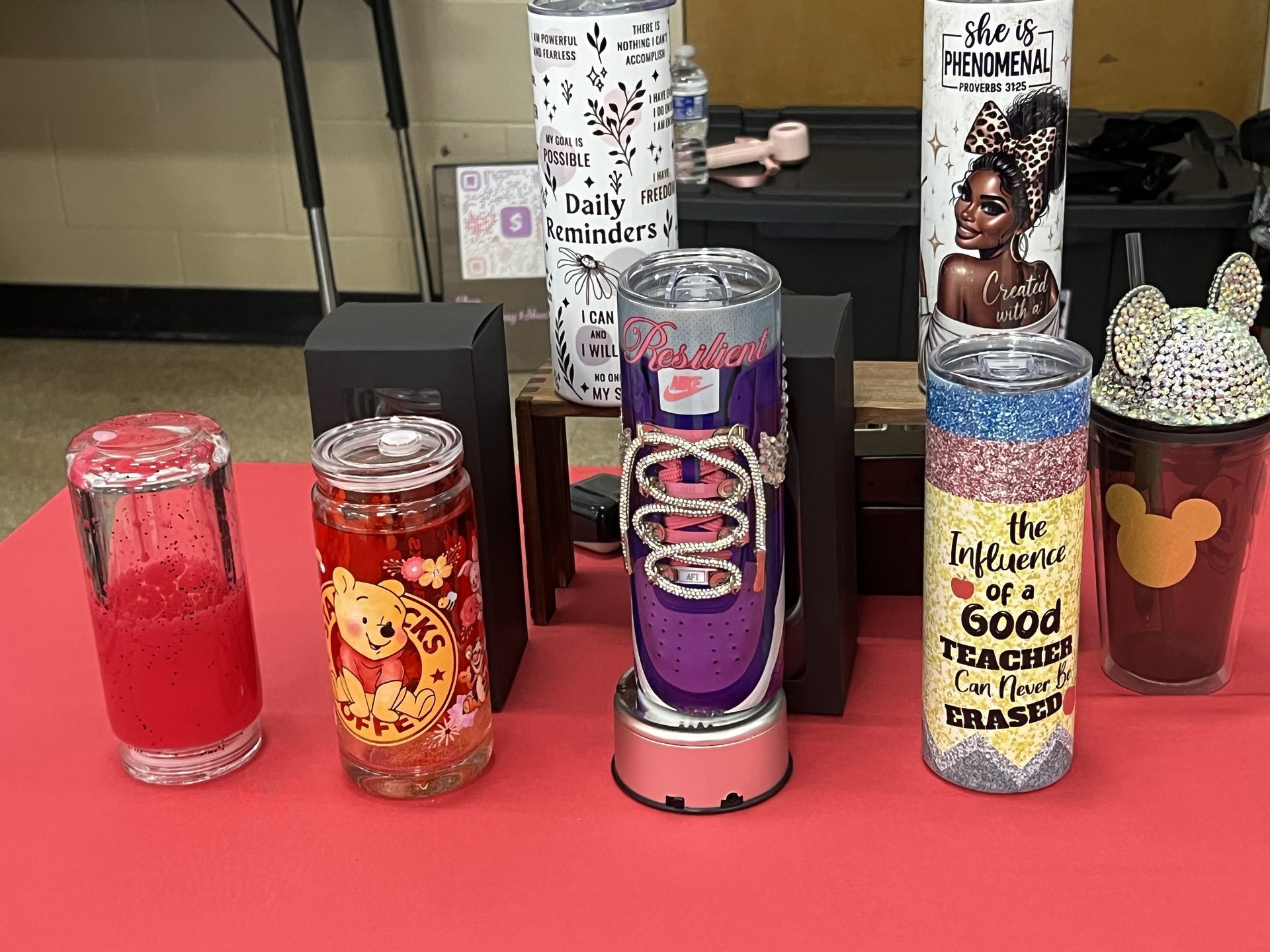 Custom personalized tumblers on vendor display table with various designs