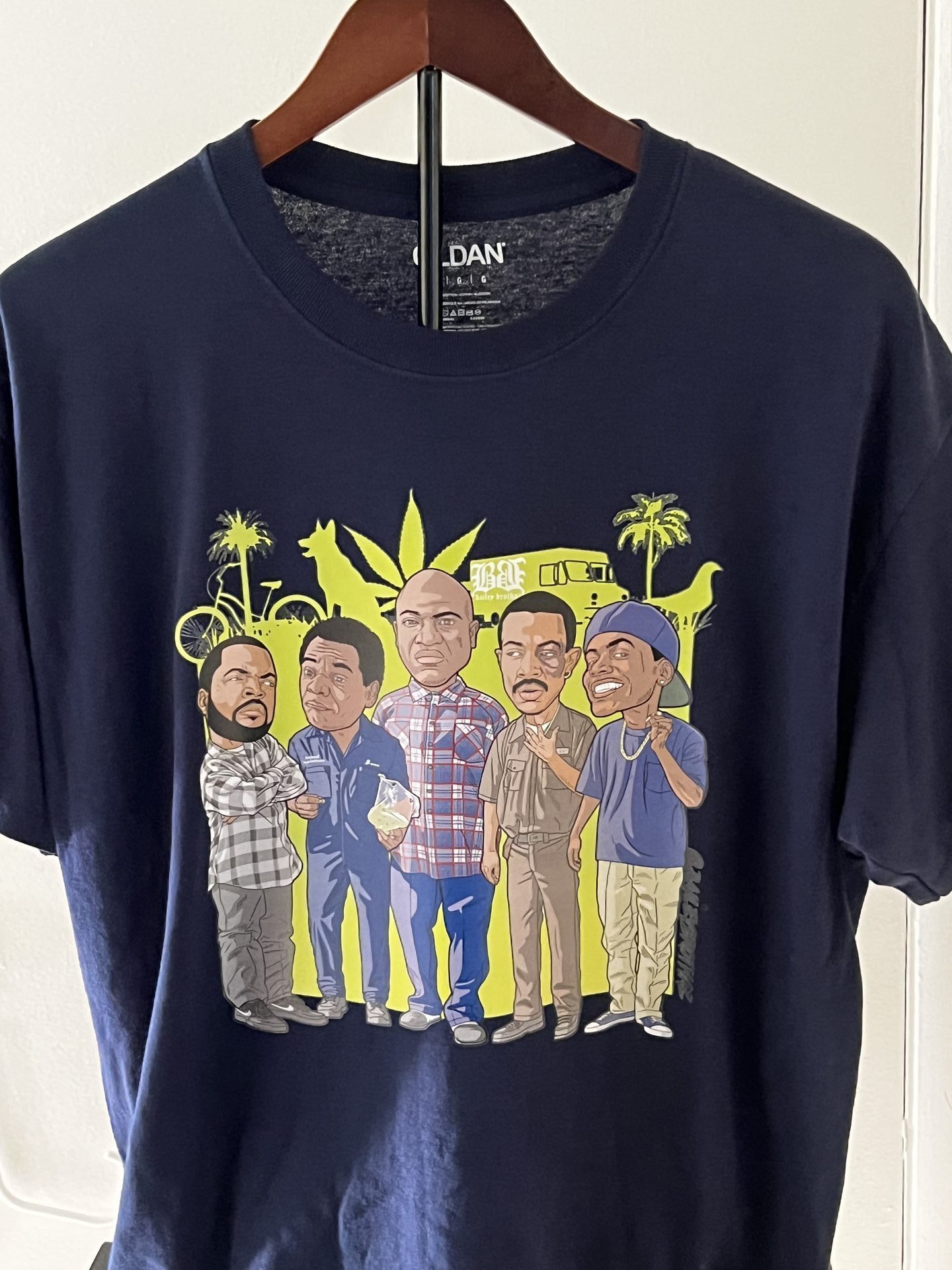 Custom navy shirt with Friday cast group caricature displayed on hanger