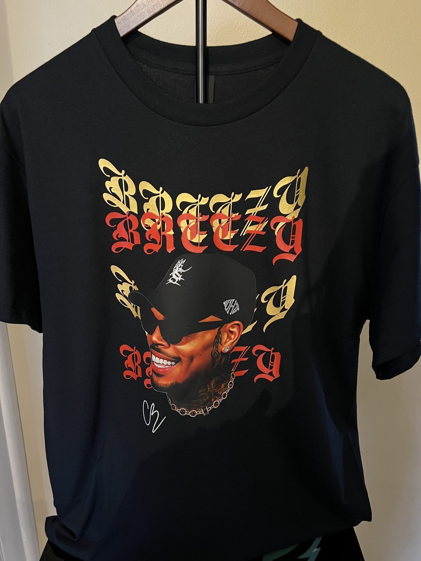 Custom black sweatshirt with rap artist portrait in gold and red lettering